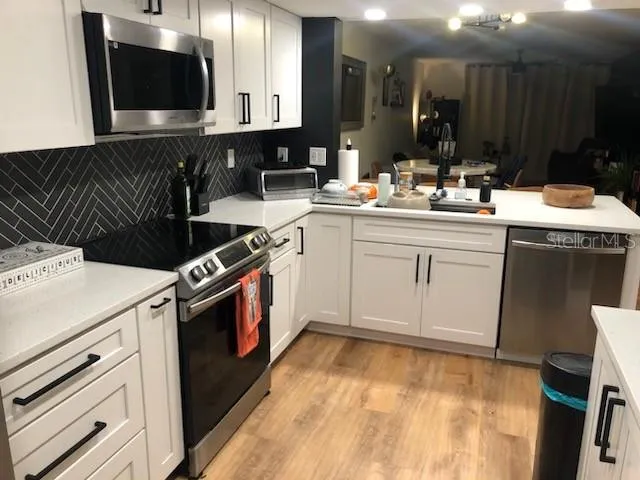 a kitchen with a sink and a stove top oven