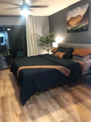 a bedroom with a bed lamp and a large mirror