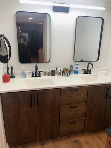 a bathroom with a double vanity sink and a mirror