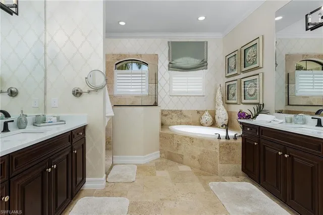a spacious bathroom with a tub sink and mirror