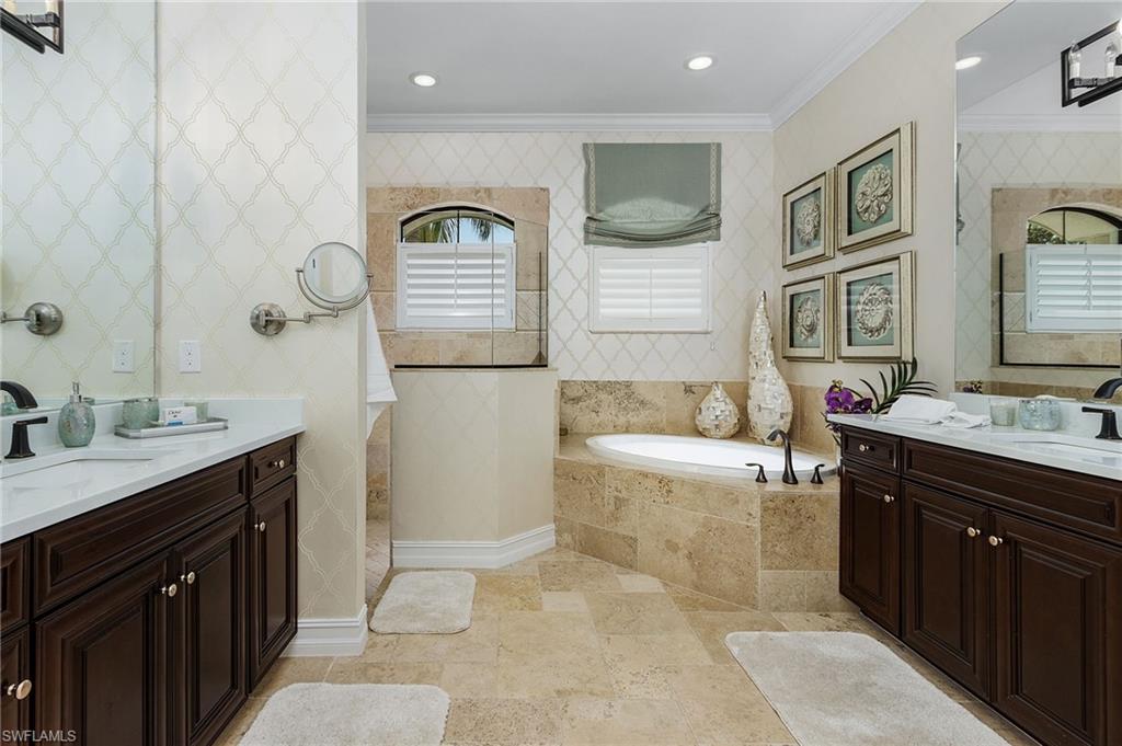 3423 Runaway Court Naples, FL 34114 - Photo 13 of 35 a spacious bathroom with a tub sink and mirror