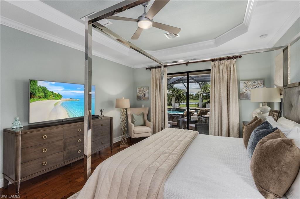 3423 Runaway Court Naples, FL 34114 - Photo 14 of 35 a bedroom with a bed and a flat tv screen on dresser