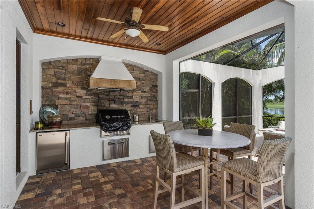 3423 Runaway Court Naples, FL 34114 - Photo 18 of 35 a dining room with furniture a fireplace and a chandelier
