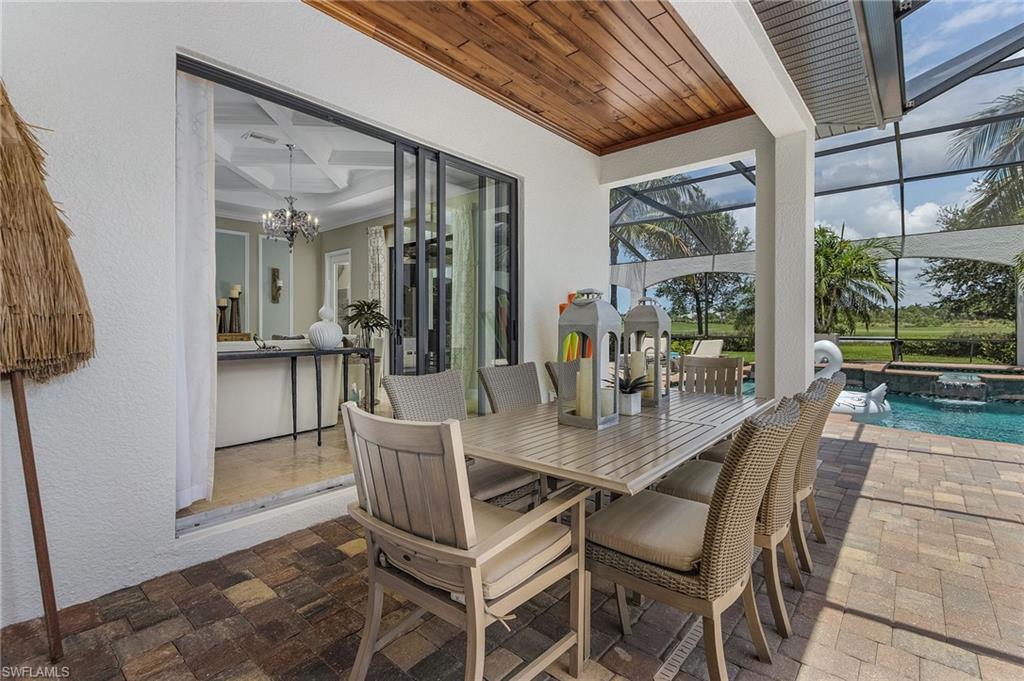 3423 Runaway Court Naples, FL 34114 - Photo 22 of 35 a dining room with furniture and large windows