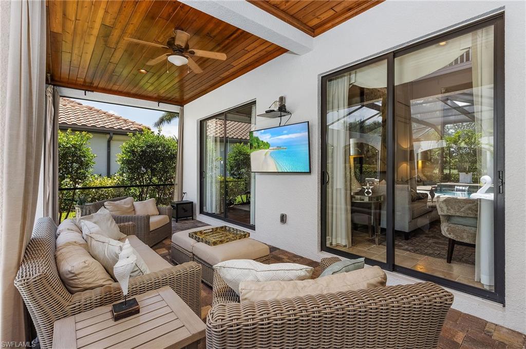 3423 Runaway Court Naples, FL 34114 - Photo 23 of 35 a bedroom with furniture and large windows
