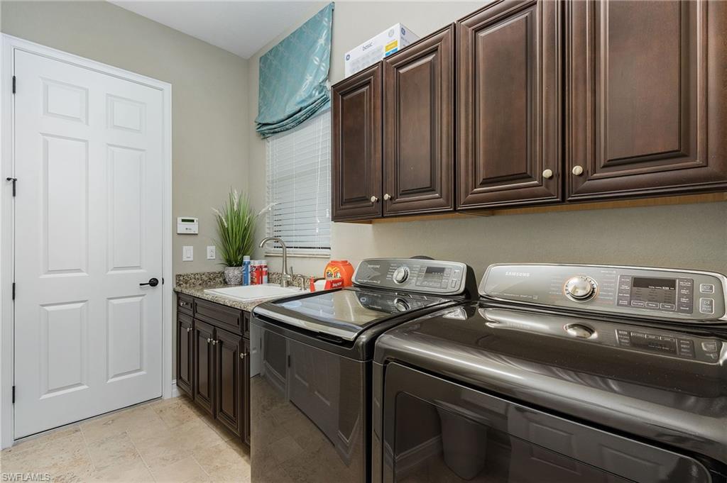 3423 Runaway Court Naples, FL 34114 - Photo 26 of 35 a kitchen with a sink and cabinets
