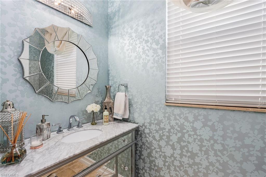 3423 Runaway Court Naples, FL 34114 - Photo 27 of 35 a bathroom with a granite countertop sink and a mirror