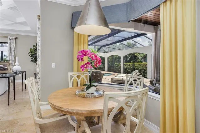 a view of a dining room with furniture and a chandelier