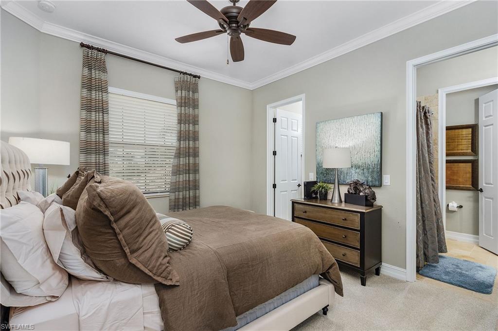 3423 Runaway Court Naples, FL 34114 - Photo 30 of 35 a bedroom with a bed and a chandelier