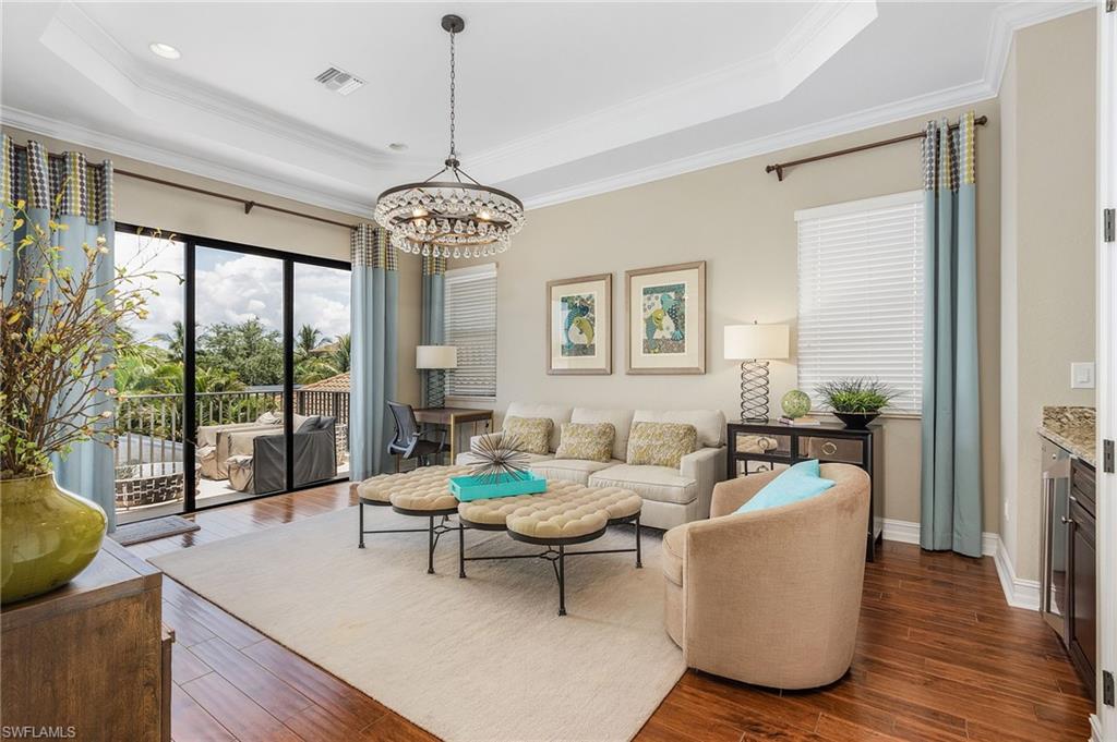 3423 Runaway Court Naples, FL 34114 - Photo 34 of 35 a living room with furniture and a large window
