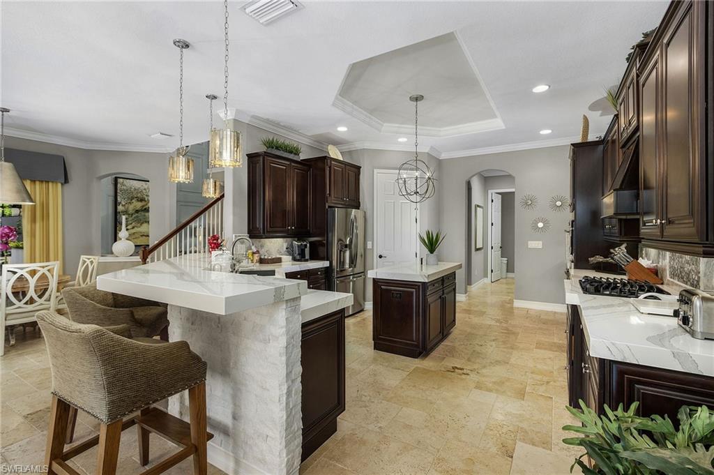 3423 Runaway Court Naples, FL 34114 - Photo 4 of 35 a large kitchen with kitchen island a sink and a refrigerator