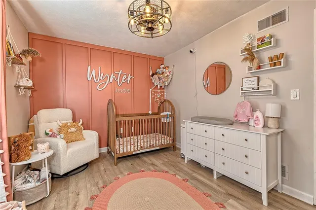 a bedroom with a bed and a chandelier