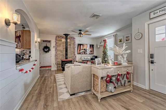 a living room with furniture and a potted plant