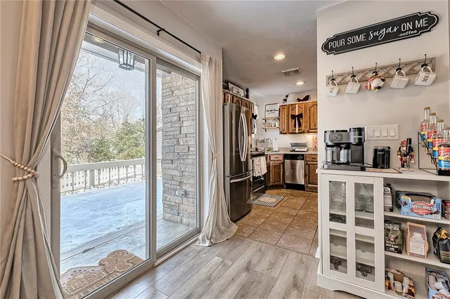 a kitchen with stainless steel appliances granite countertop a refrigerator and a sink