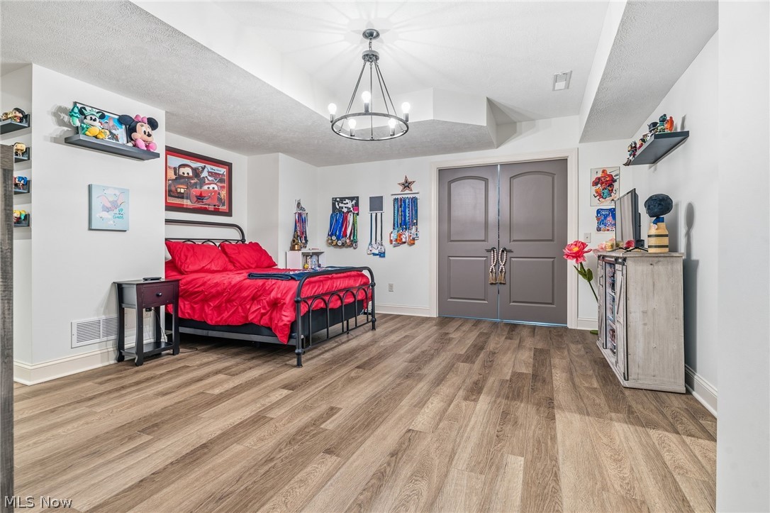 421 Pontius Road Mogadore, OH 44260 - Photo 25 of 50 Wood-finish flooring throughout, paired with a contemporary chandelier and recessed lighting