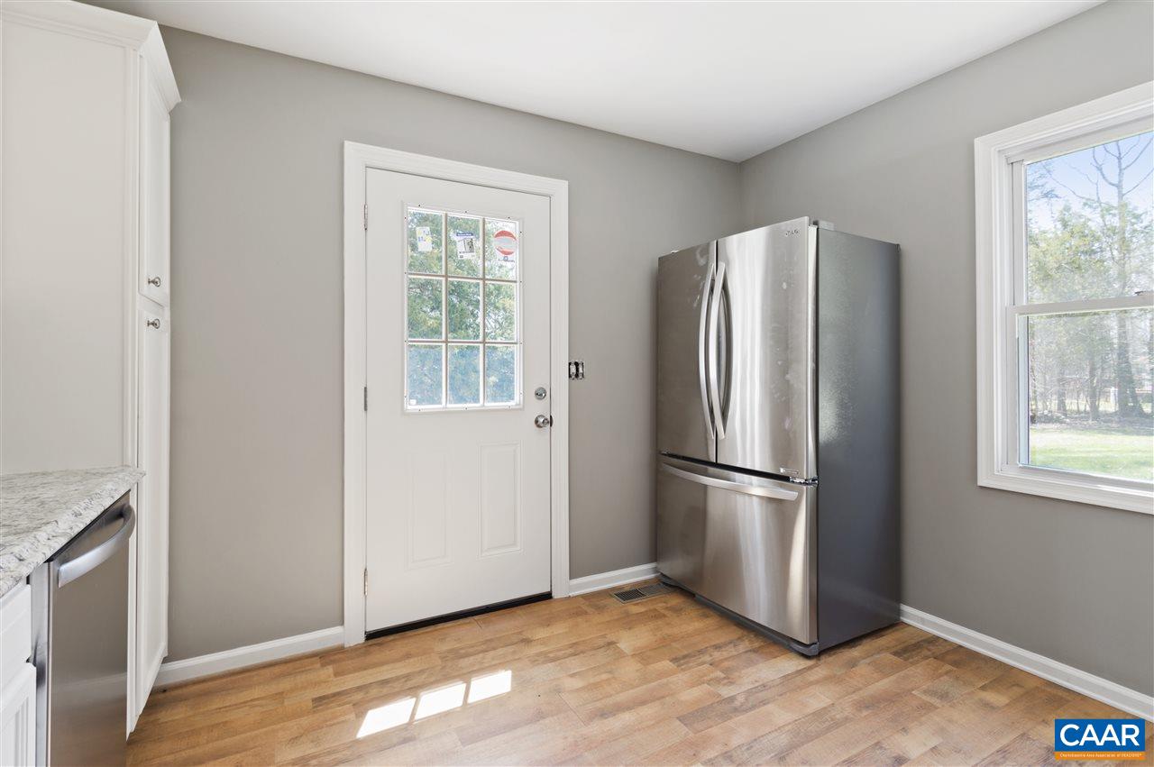 3915 Stage Junction Road Columbia, VA 23038 - Photo 4 of 11 a view of a kitchen with wooden floor and refrigerator