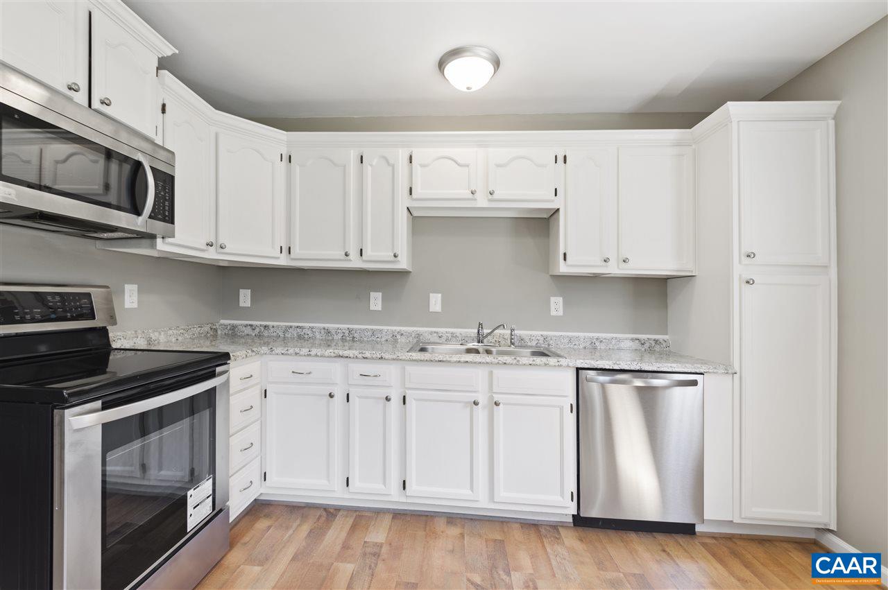 3915 Stage Junction Road Columbia, VA 23038 - Photo 5 of 11 a kitchen with stainless steel appliances granite countertop a sink and a stove