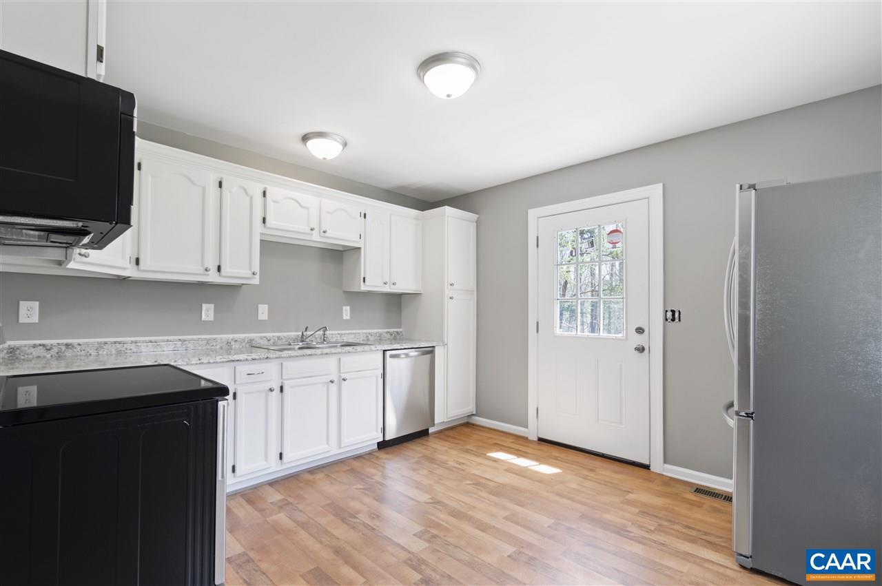 3915 Stage Junction Road Columbia, VA 23038 - Photo 6 of 11 a kitchen with granite countertop a sink and a stove top oven