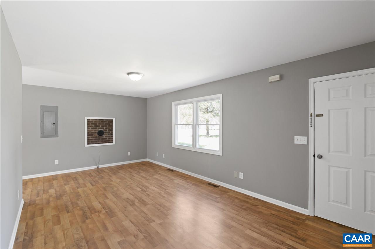3915 Stage Junction Road Columbia, VA 23038 - Photo 7 of 11 an empty room with wooden floor and windows