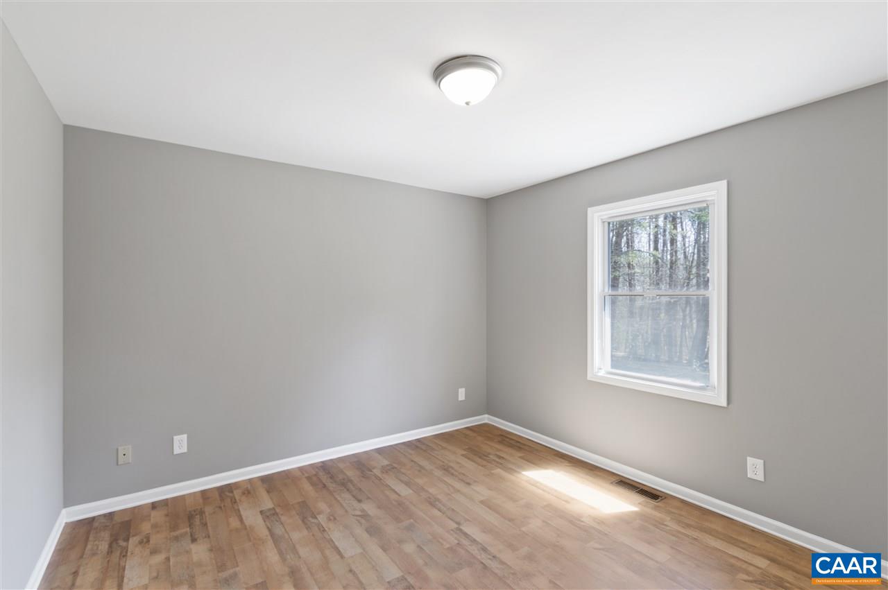 3915 Stage Junction Road Columbia, VA 23038 - Photo 9 of 11 an empty room with wooden floor and windows