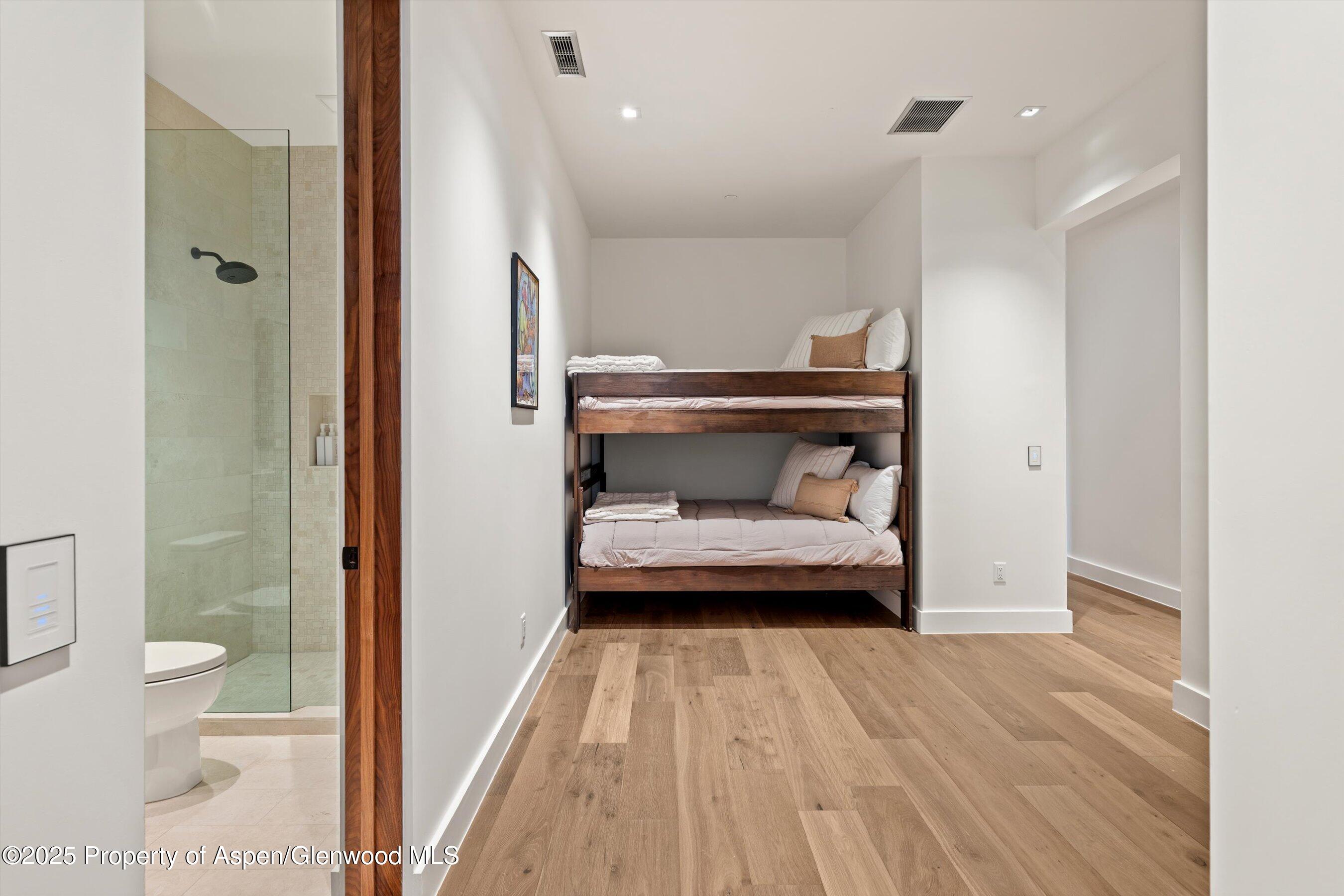1234 Wood Road Snowmass Village, CO 81615 - Photo 55 of 66 a bedroom with a bed and a view of en suite bathroom