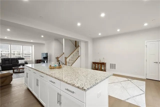 a kitchen with stainless steel appliances granite countertop a sink and a refrigerator