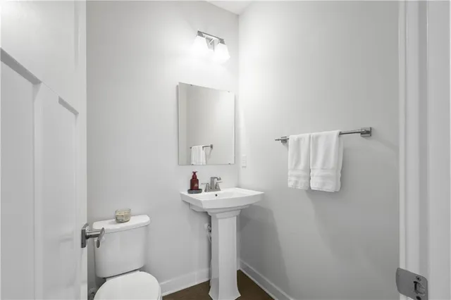 a bathroom with a sink mirror and toilet