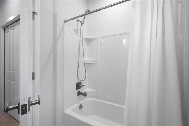 a bathroom with a shower and a shower