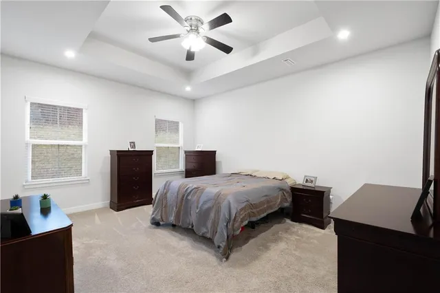 a spacious bedroom with a bed and a window