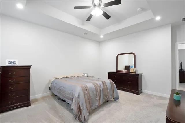 a bedroom with a bed and ceiling fan