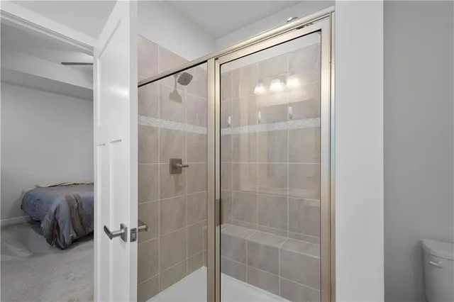 a bathroom with a glass shower door