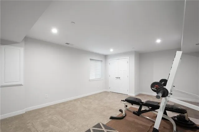 a room with gym equipment and a window