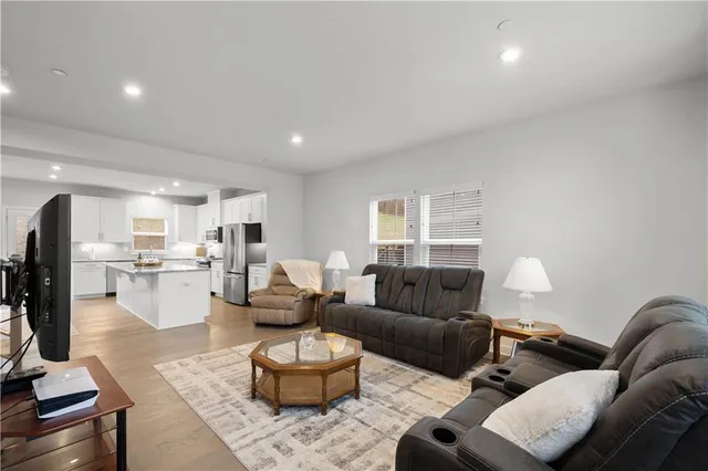 a living room with furniture and wooden floor