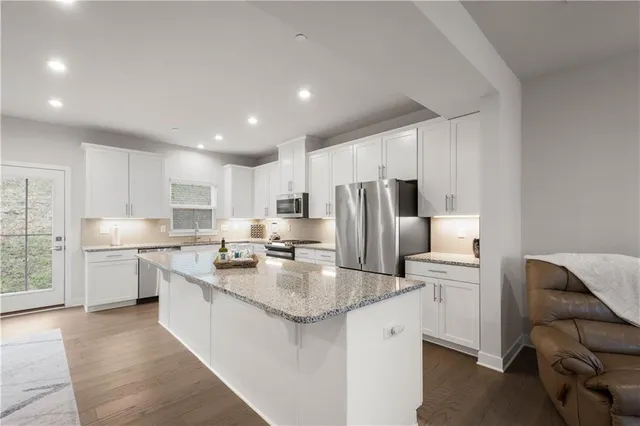 a kitchen with stainless steel appliances a refrigerator sink and cabinets