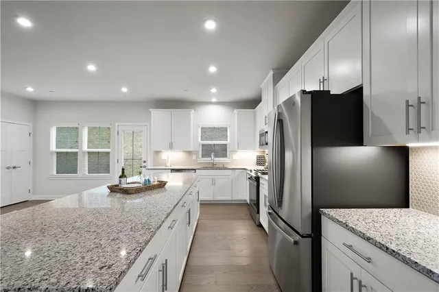 a kitchen with a refrigerator and a sink