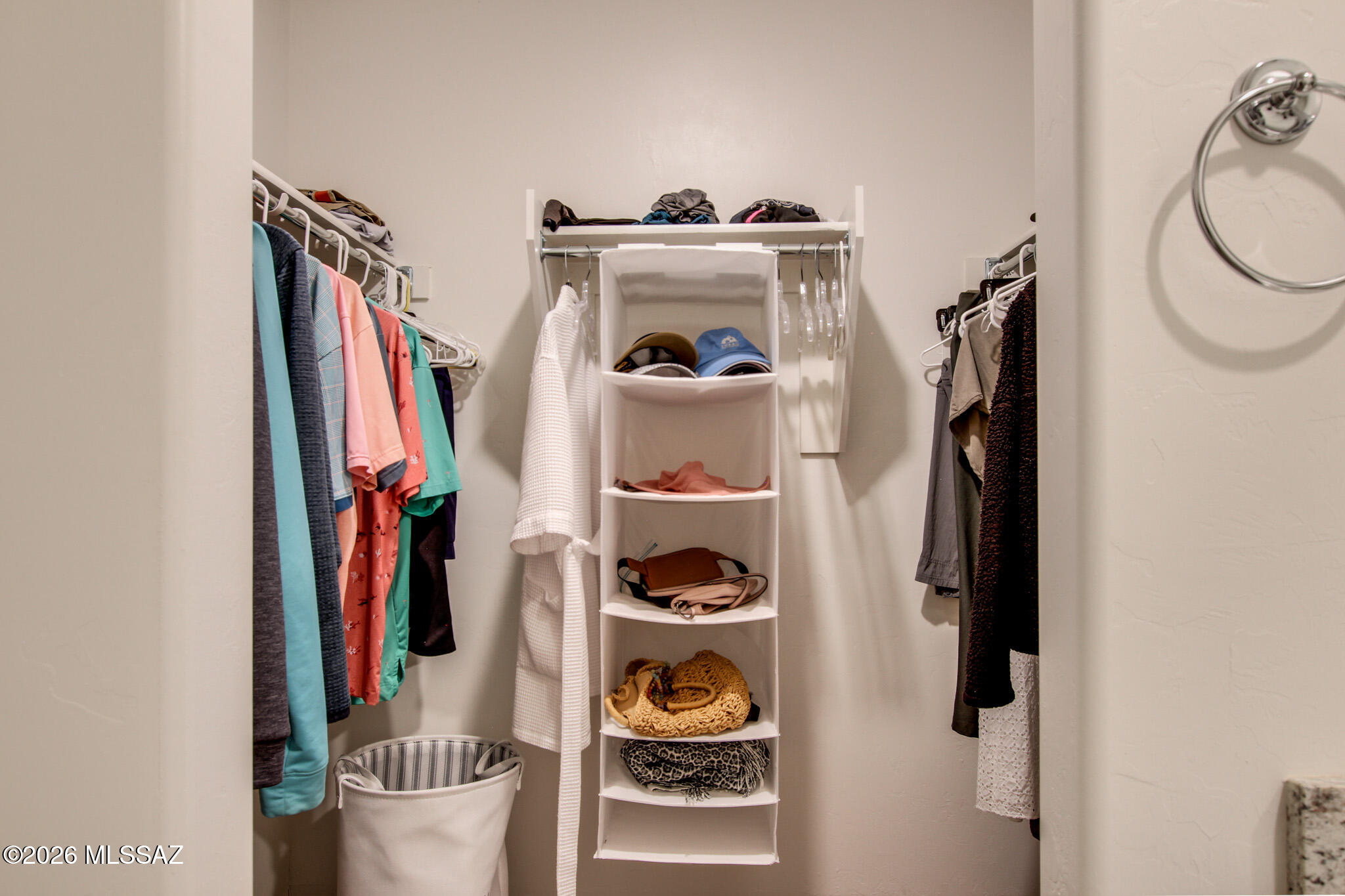 7056 South Draper Road Tucson, AZ 85757 - Photo 19 of 22 a view of walk in closet with clothes and shoes