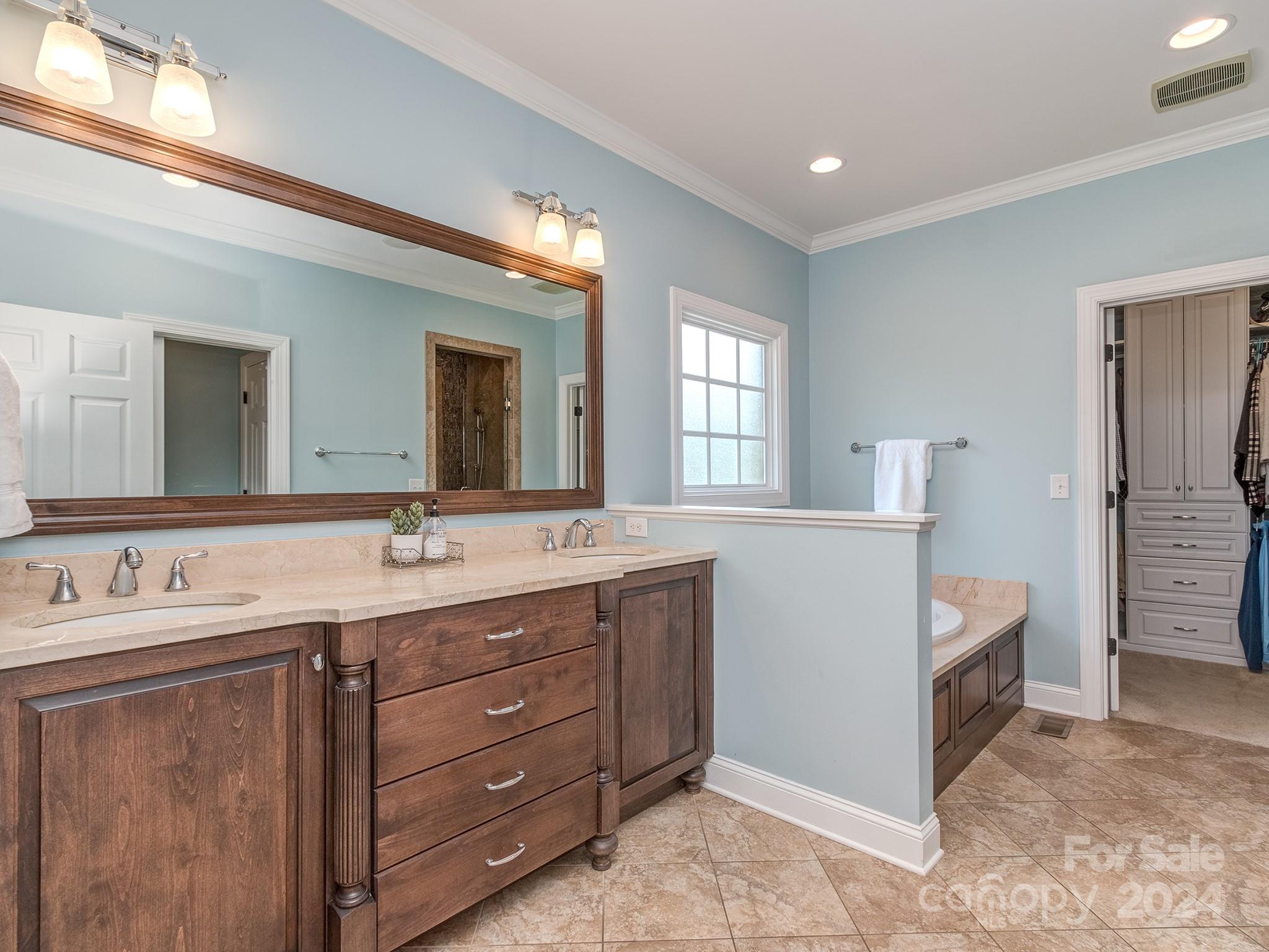 2028 Maynard Road Charlotte, NC 28270 - Photo 13 of 34 a spacious bathroom with a double vanity sink and a mirror