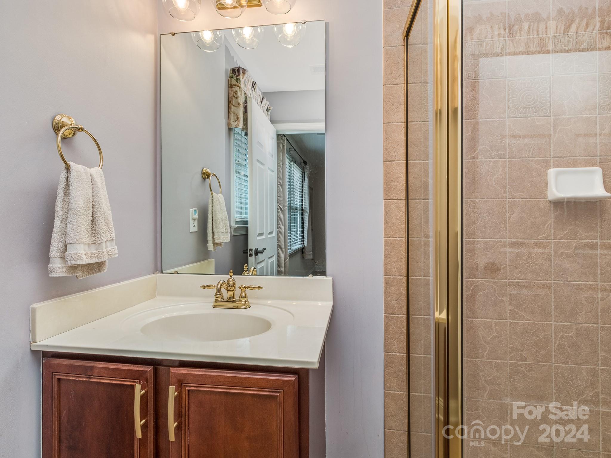 2028 Maynard Road Charlotte, NC 28270 - Photo 16 of 34 a bathroom with a granite countertop sink and a mirror