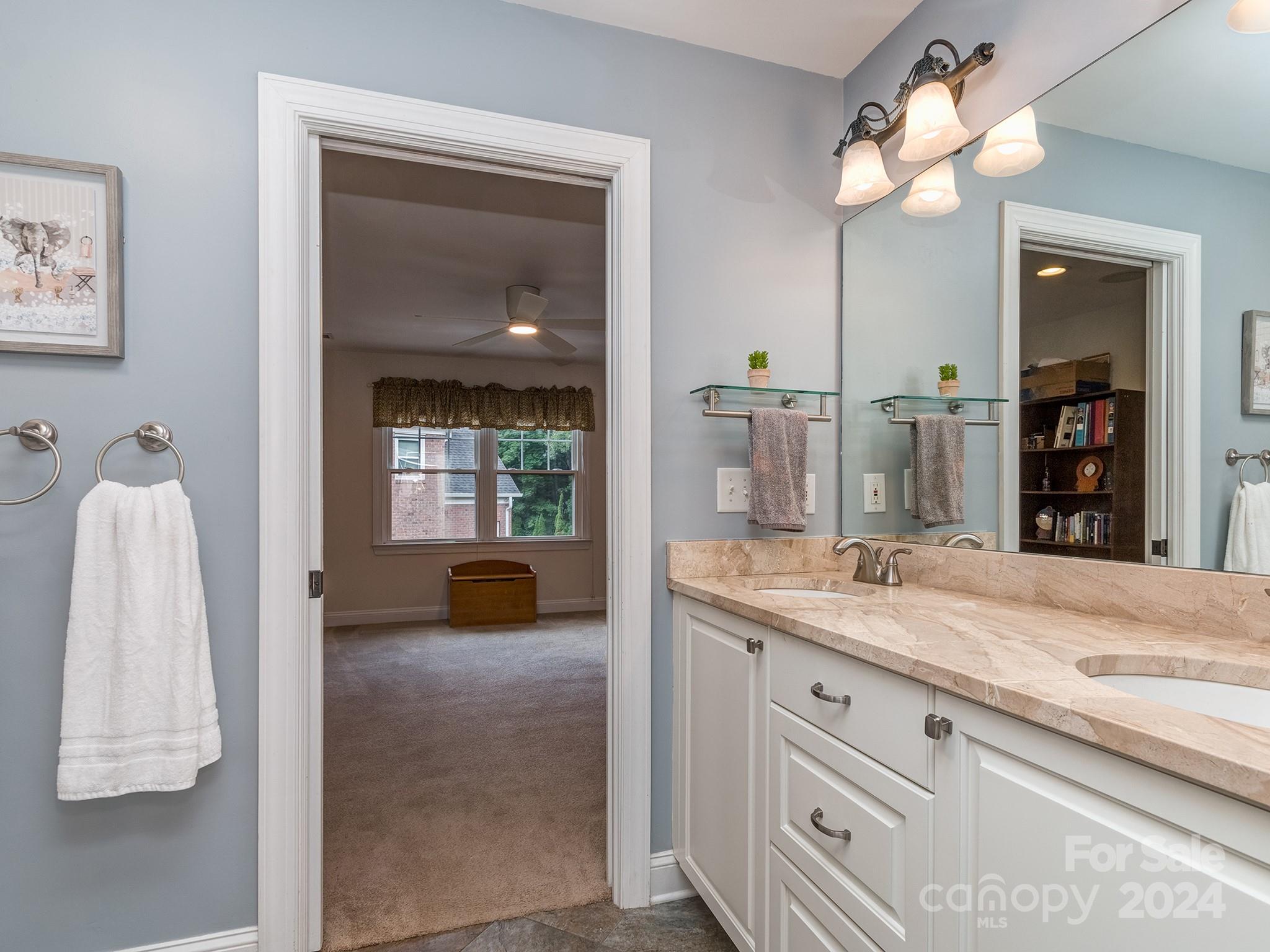 2028 Maynard Road Charlotte, NC 28270 - Photo 18 of 34 a en suite bathroom with a granite countertop sink and a mirror
