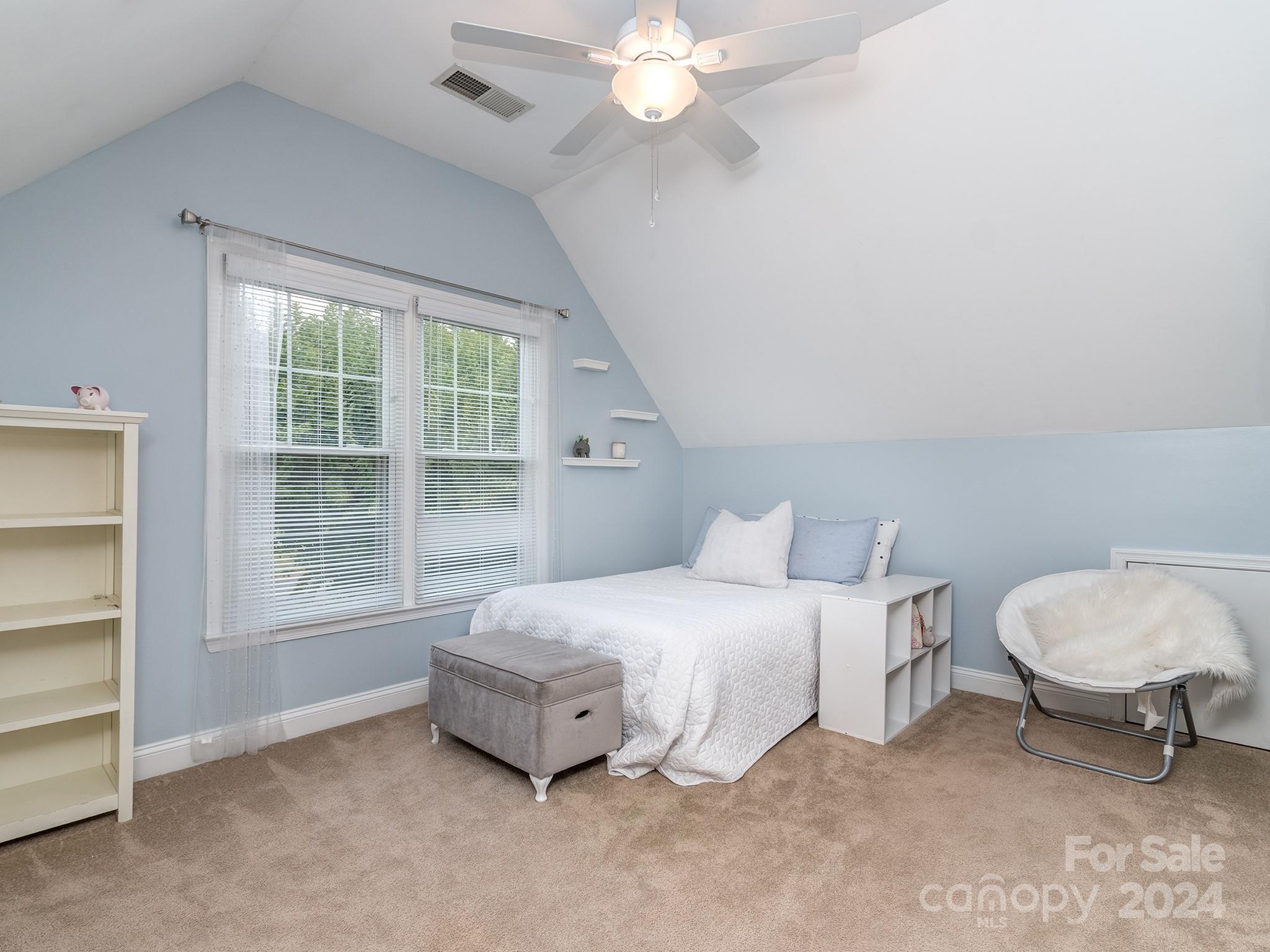 2028 Maynard Road Charlotte, NC 28270 - Photo 19 of 34 a bedroom with a bed a chandelier and a window