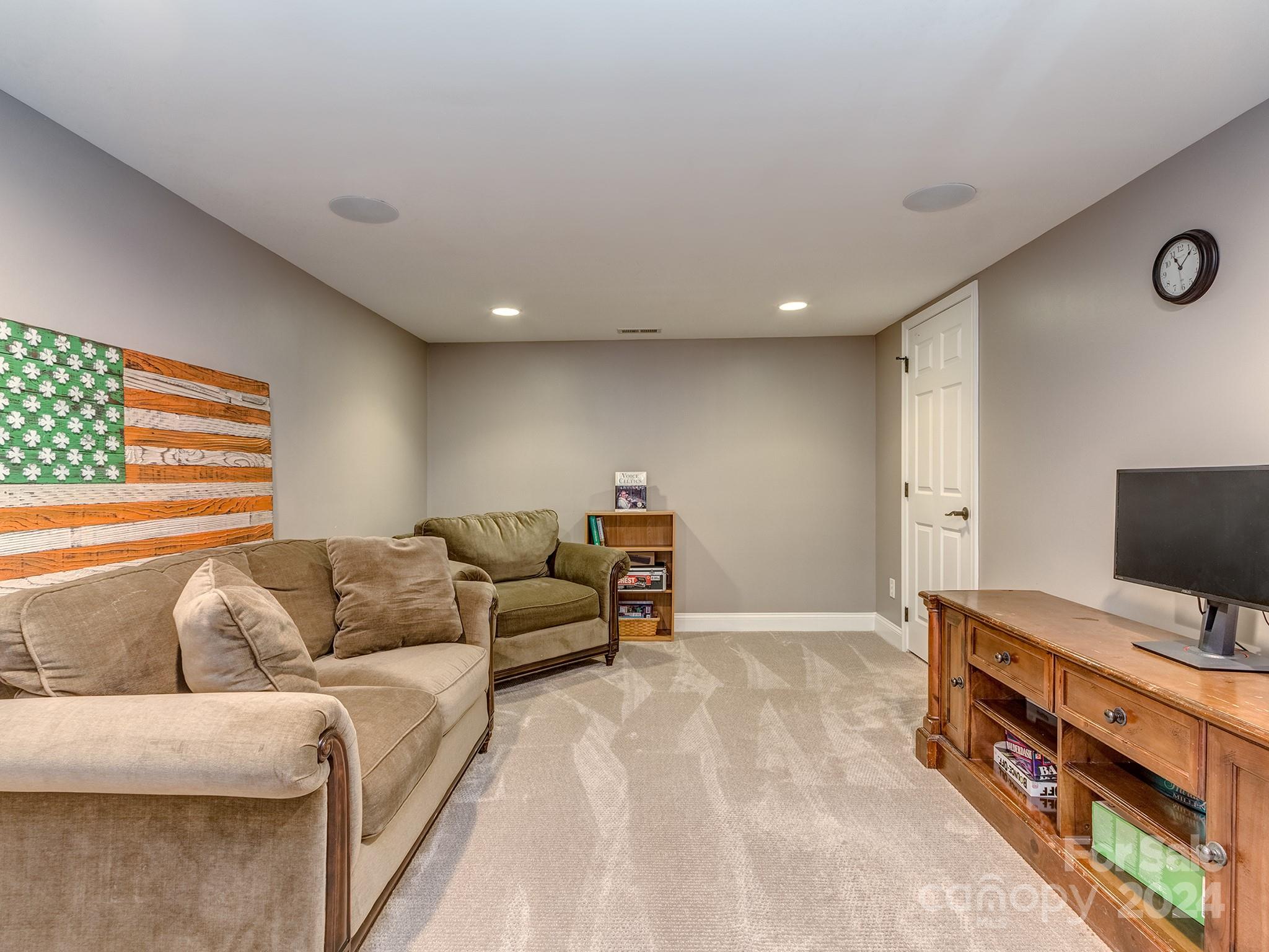 2028 Maynard Road Charlotte, NC 28270 - Photo 26 of 34 a living room with furniture and a flat screen tv