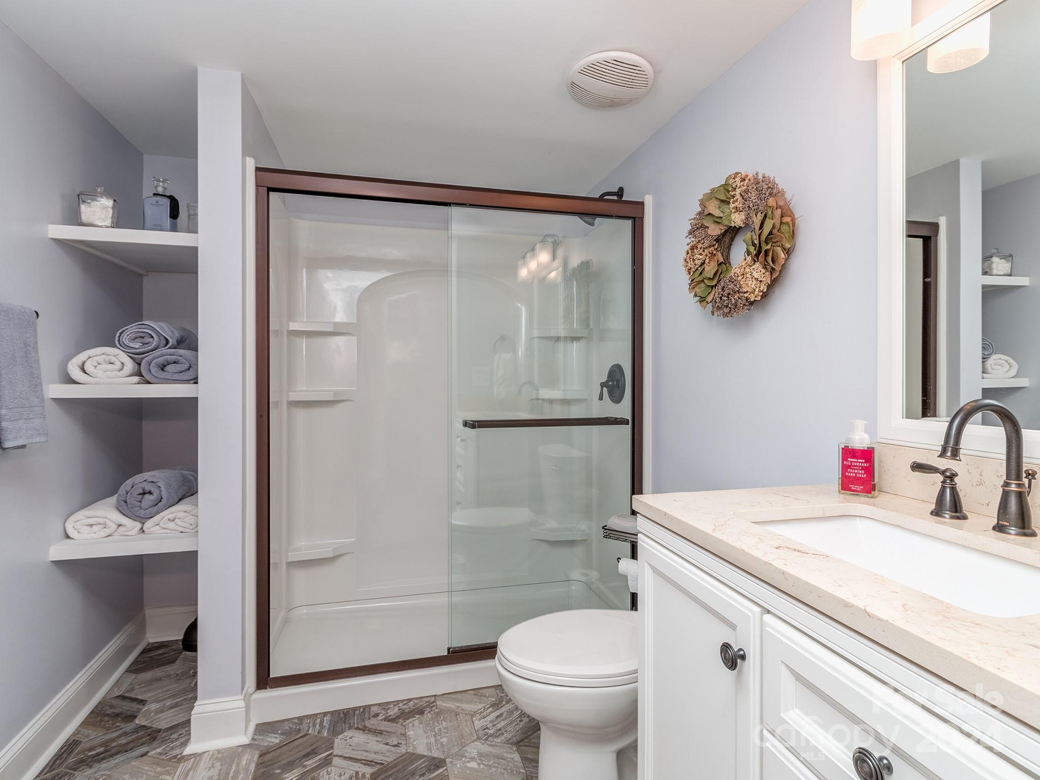 2028 Maynard Road Charlotte, NC 28270 - Photo 28 of 34 a bathroom with a granite countertop sink toilet a mirror and shower