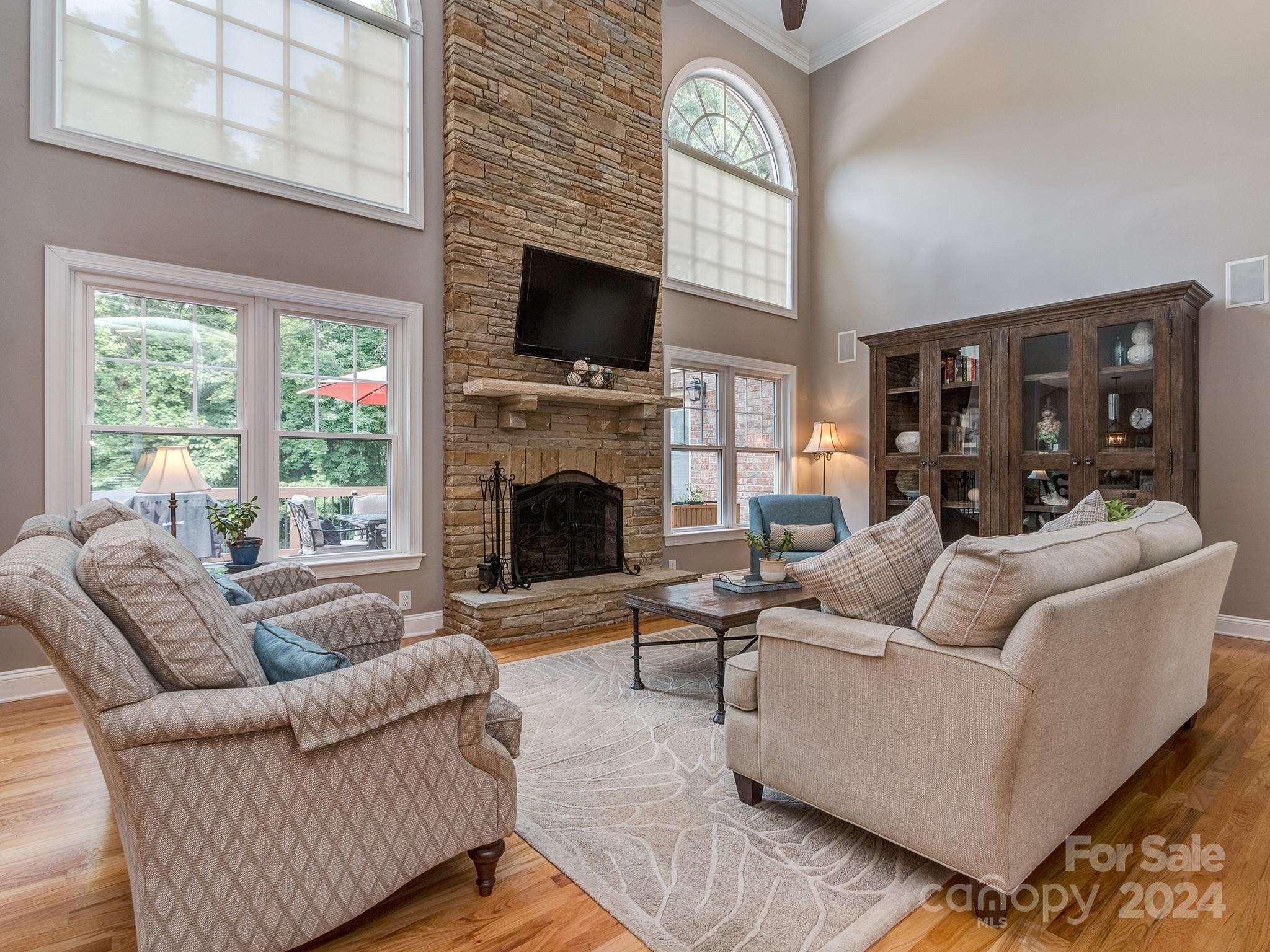 2028 Maynard Road Charlotte, NC 28270 - Photo 3 of 34 a living room with furniture a flat screen tv and a fireplace