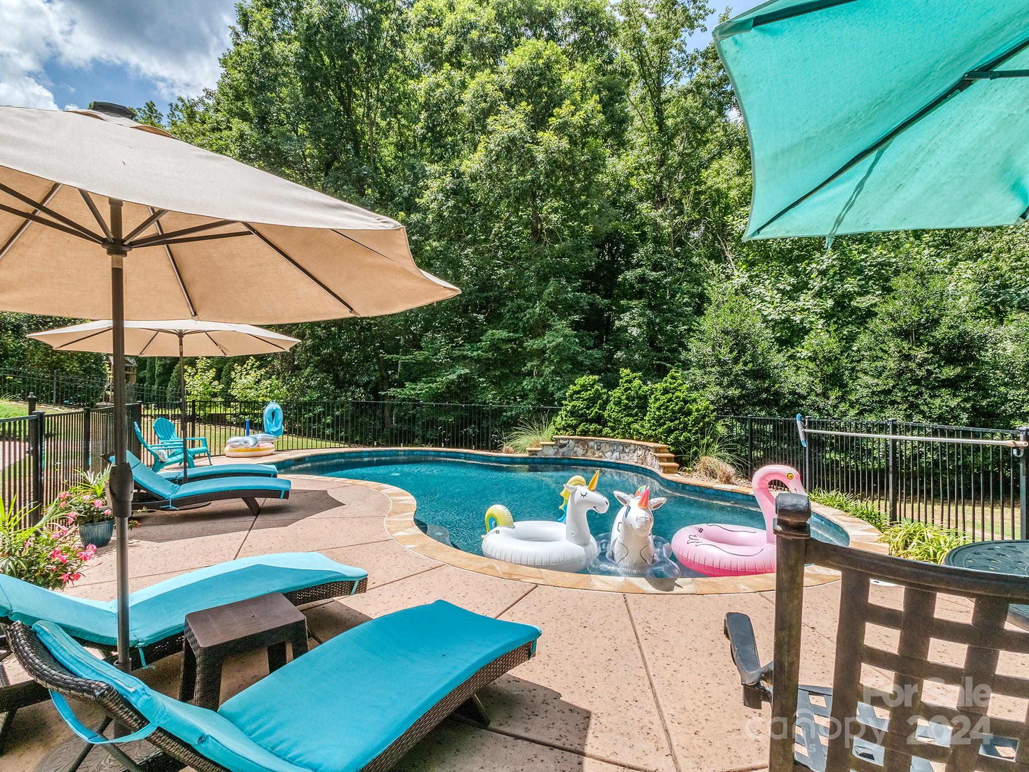 2028 Maynard Road Charlotte, NC 28270 - Photo 32 of 34 a view of a patio with chairs under an umbrella