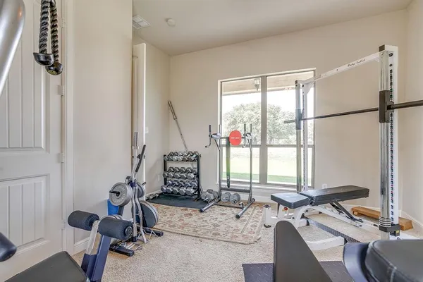 a room with gym equipment and a large window