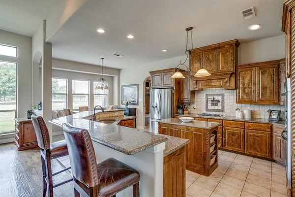 a view of a dining room and livingroom with furniture wooden floor a chandelier