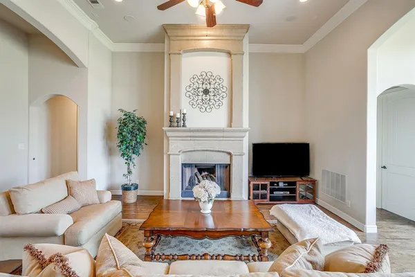 a living room with furniture a fireplace and a flat screen tv
