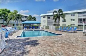 a view of a house with swimming pool and sitting area