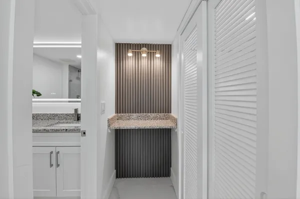 a view of bathroom with a sink and mirror