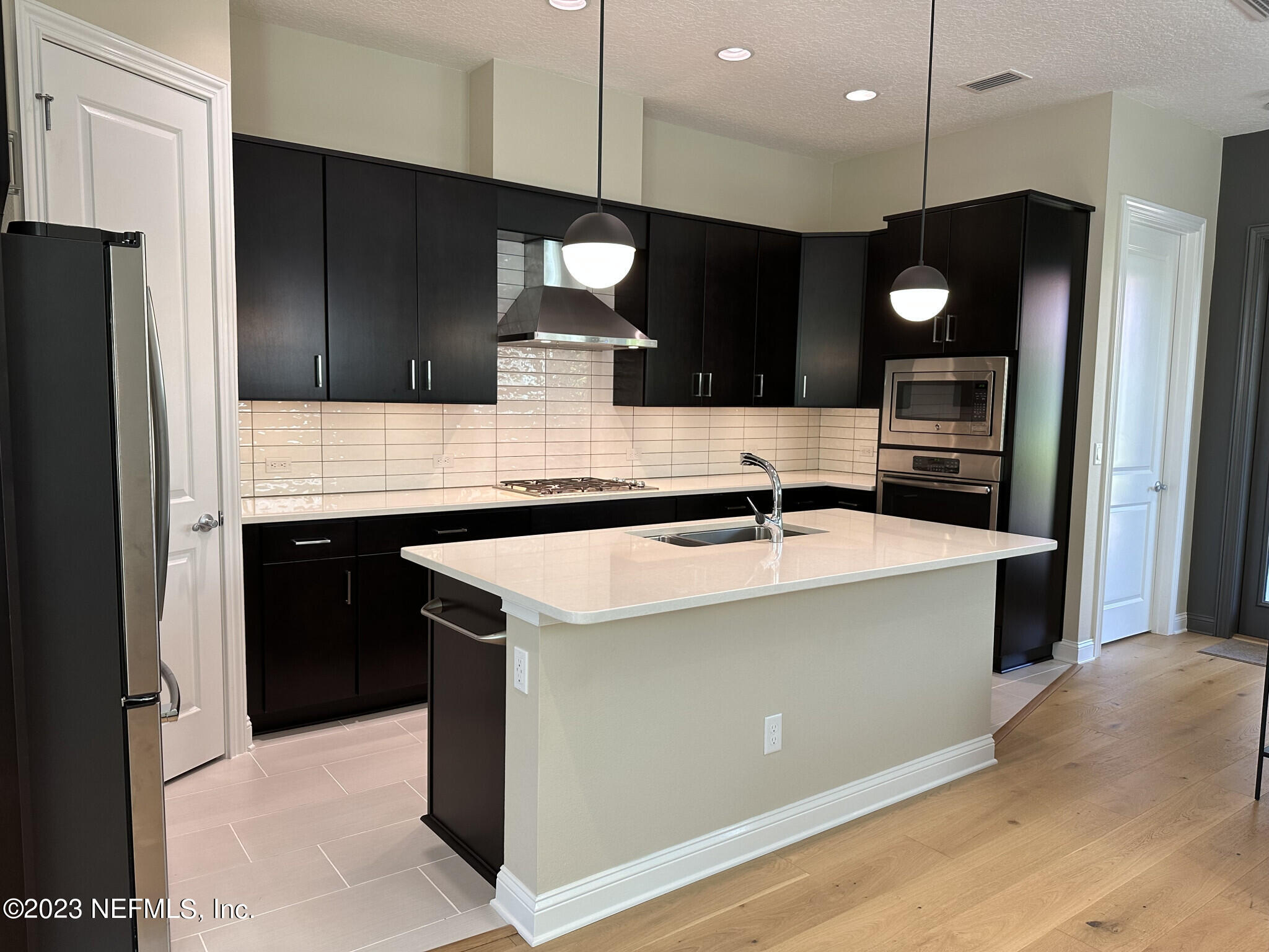 44 Rinaldo Way Ponte Vedra, FL 32081 - Photo 15 of 30 a kitchen with a sink a counter space stainless steel appliances and cabinets